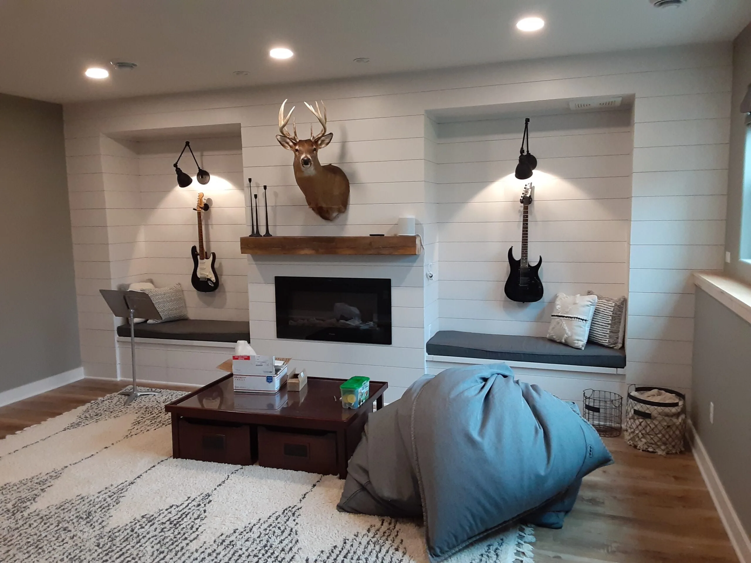 Basement rec room with shiplap fireplace