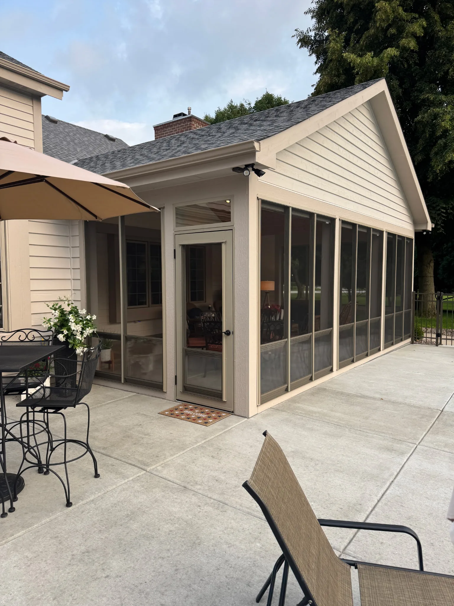 Angled view of screened porch with entry door